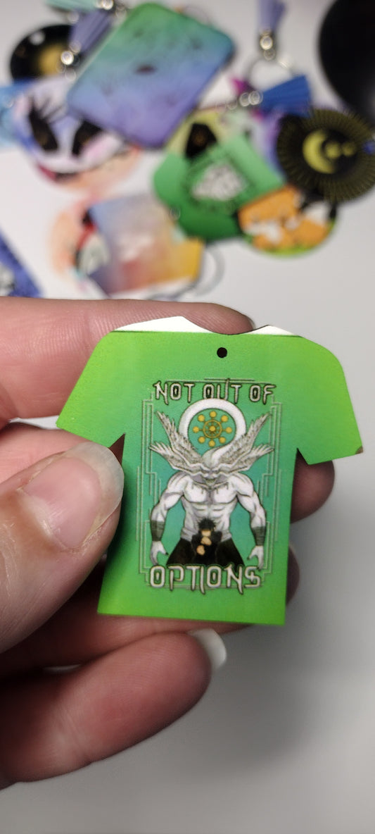 closeup of a tshirt shaped keychain that has an image of an anime character Megumi in front of Mahoraga. The keychain is imperfect, with a white line on the top. 